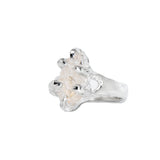 Silver ring with a clear gemstone on a white background