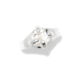 Silver ring with a clear gemstone on a white background