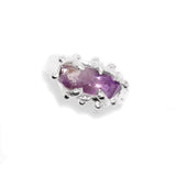 Silver earring with a purple gemstone on a white background