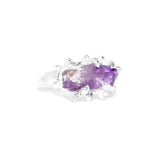 Silver ring with a purple gemstone on a white background