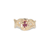 Gold ring with a red ruby gemstone on a white background