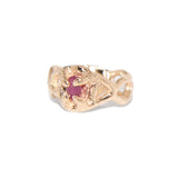 Gold ring with a pink gemstone on a white background