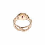 Gold ring with a red gemstone on a white background