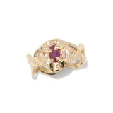 Gold ring with a red gemstone on a white background