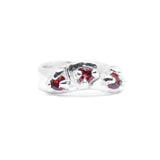 Silver ring with red gemstones on a white background
