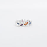 Ring with colourful sapphire on a white background