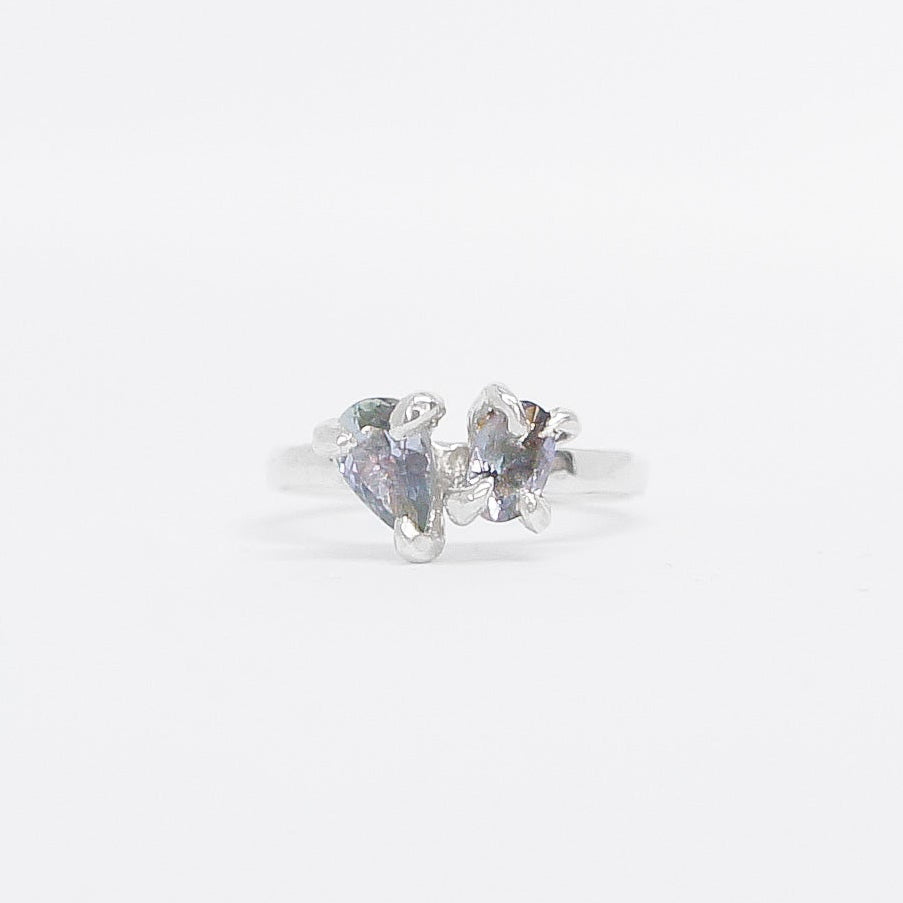 Silver ring toi et moi design with gemstone on a white background