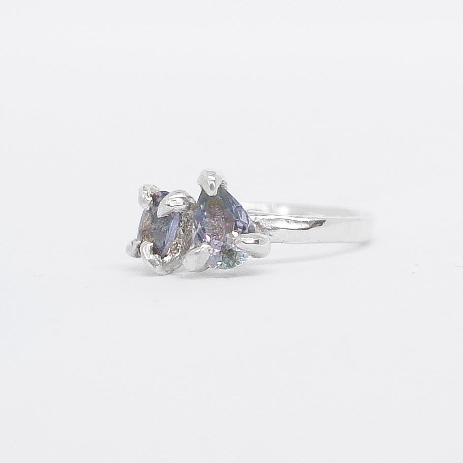 Silver ring toi et moi design with gemstone on a white background