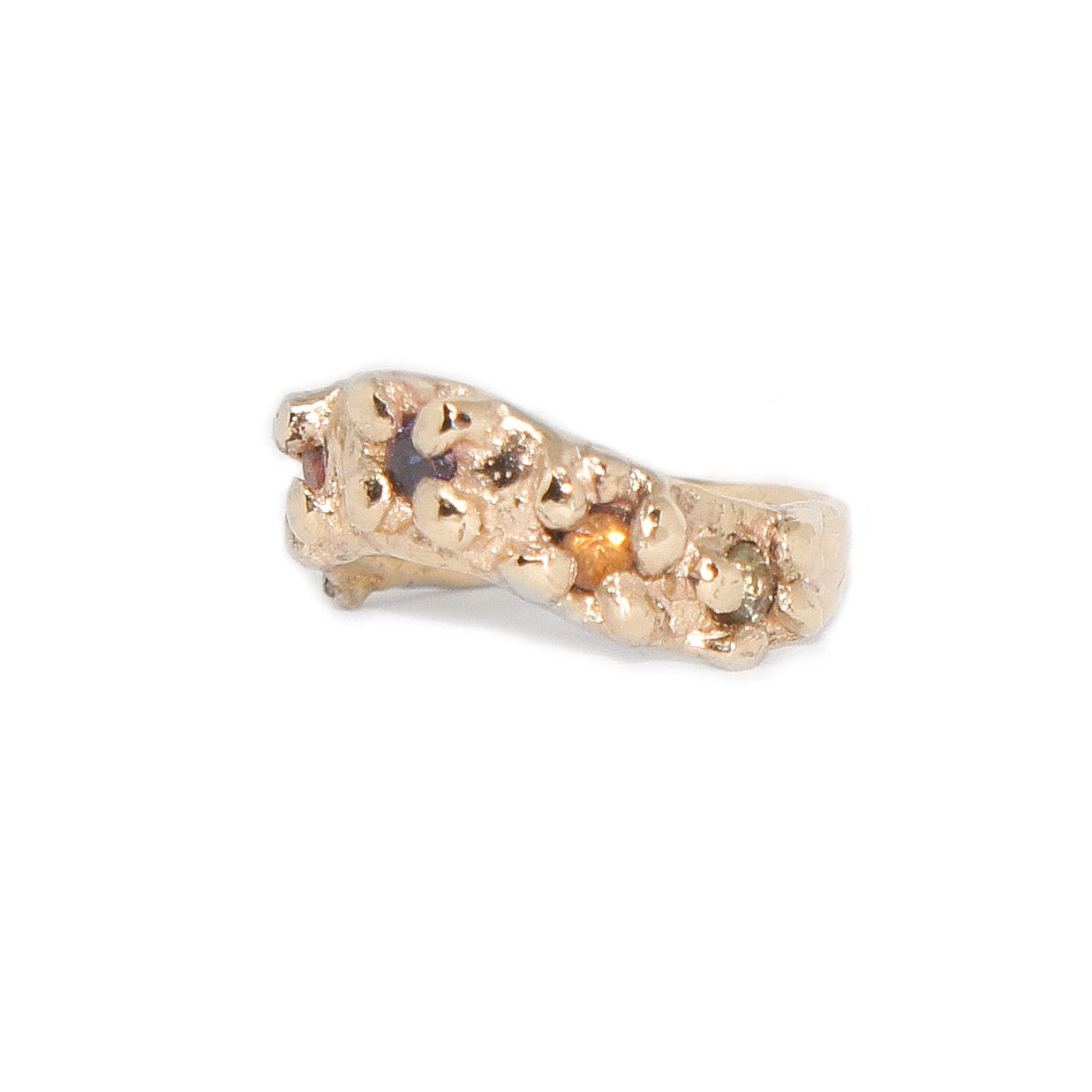 Gold ring with embedded stones on a white background