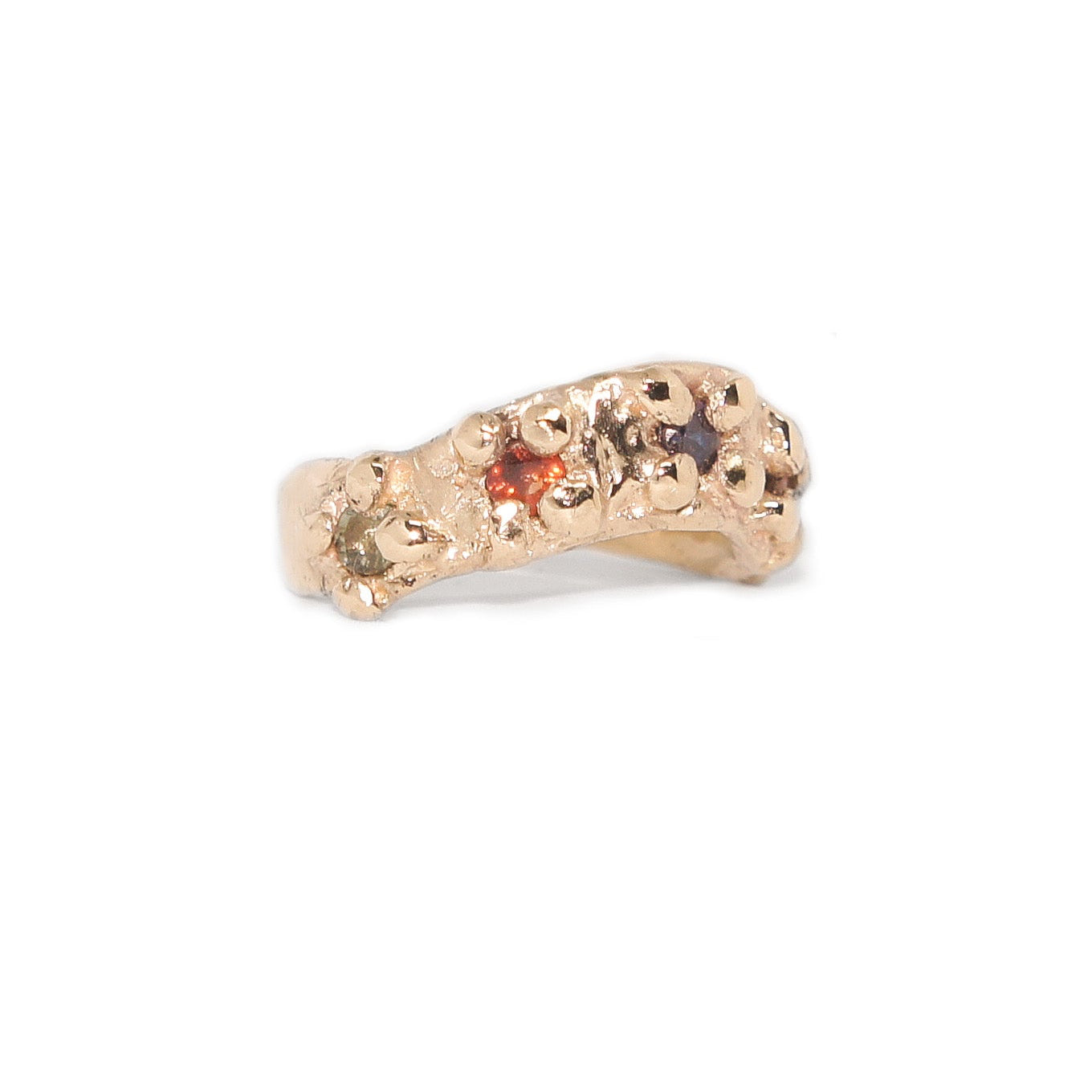 Gold ring with embedded gemstones on a white background