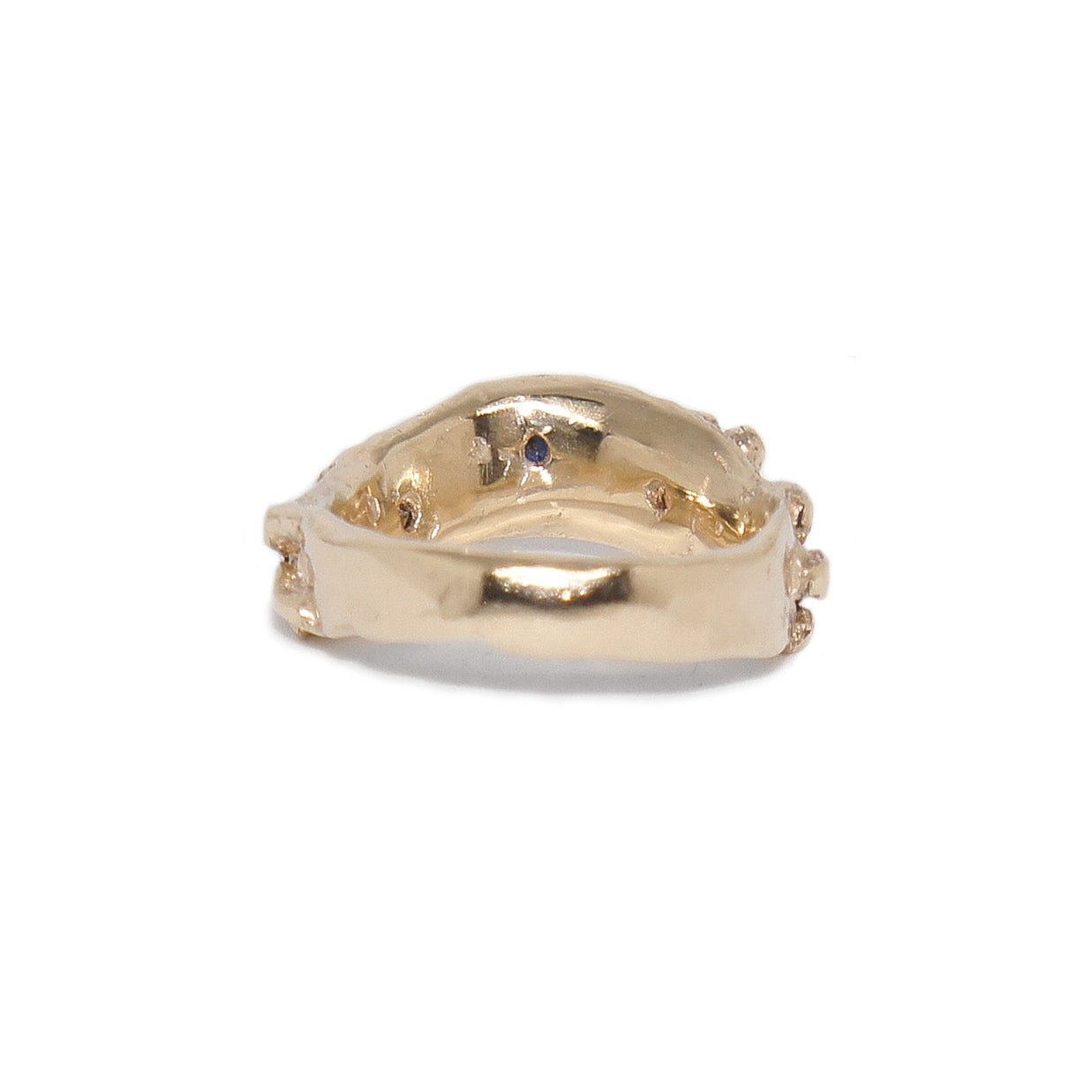 Gold ring with a unique design on a white background