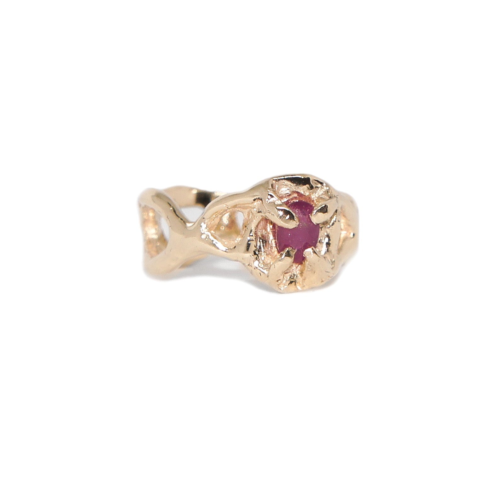 Gold ring with a red gemstone on a white background