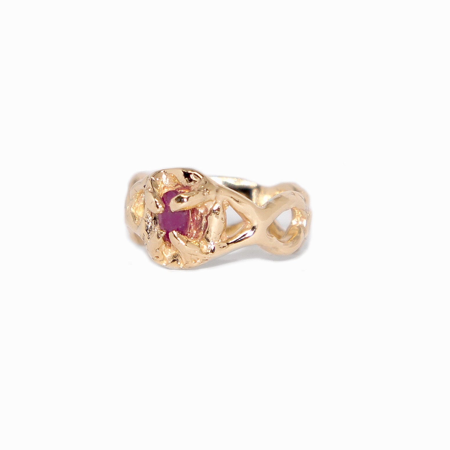 Gold ring with a red gemstone on a white background