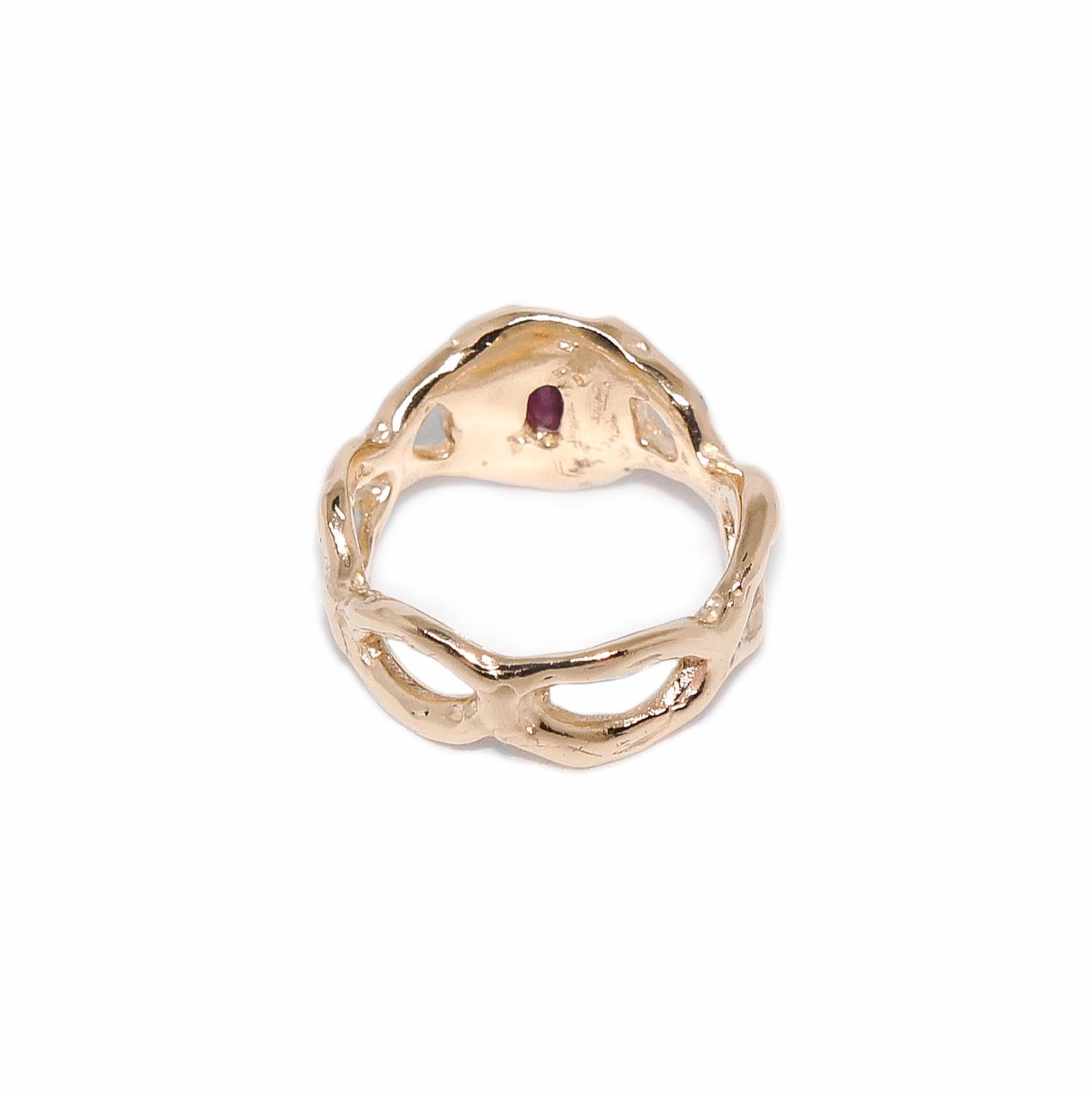 Gold ring with a red gemstone on a white background