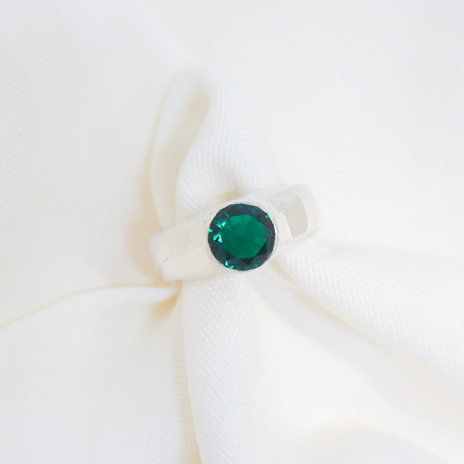 Green gemstone earring on a white background