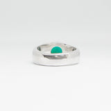 Silver ring with a emerald stone on a white background