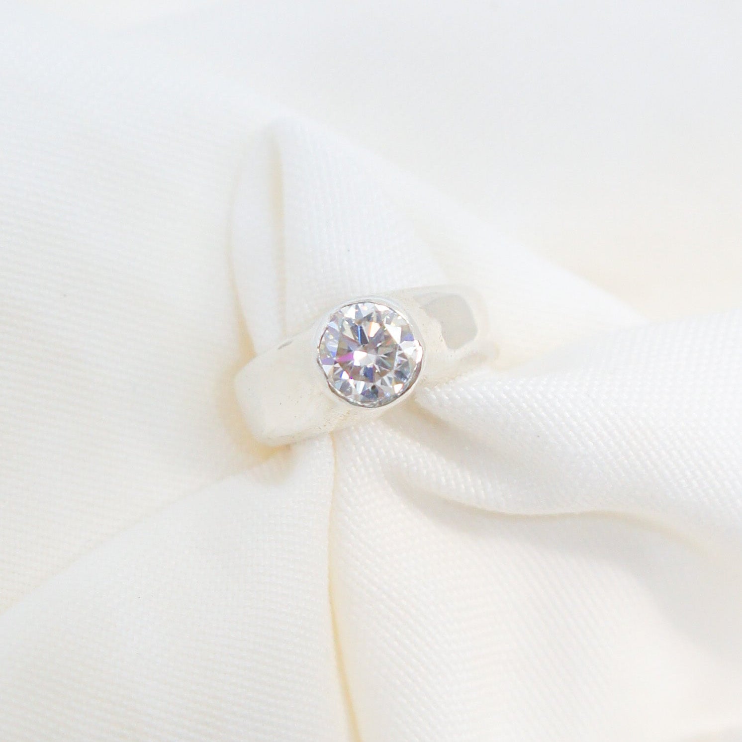 Close-up of a diamond earring on a white background