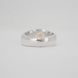 Silver ring on a light gray background