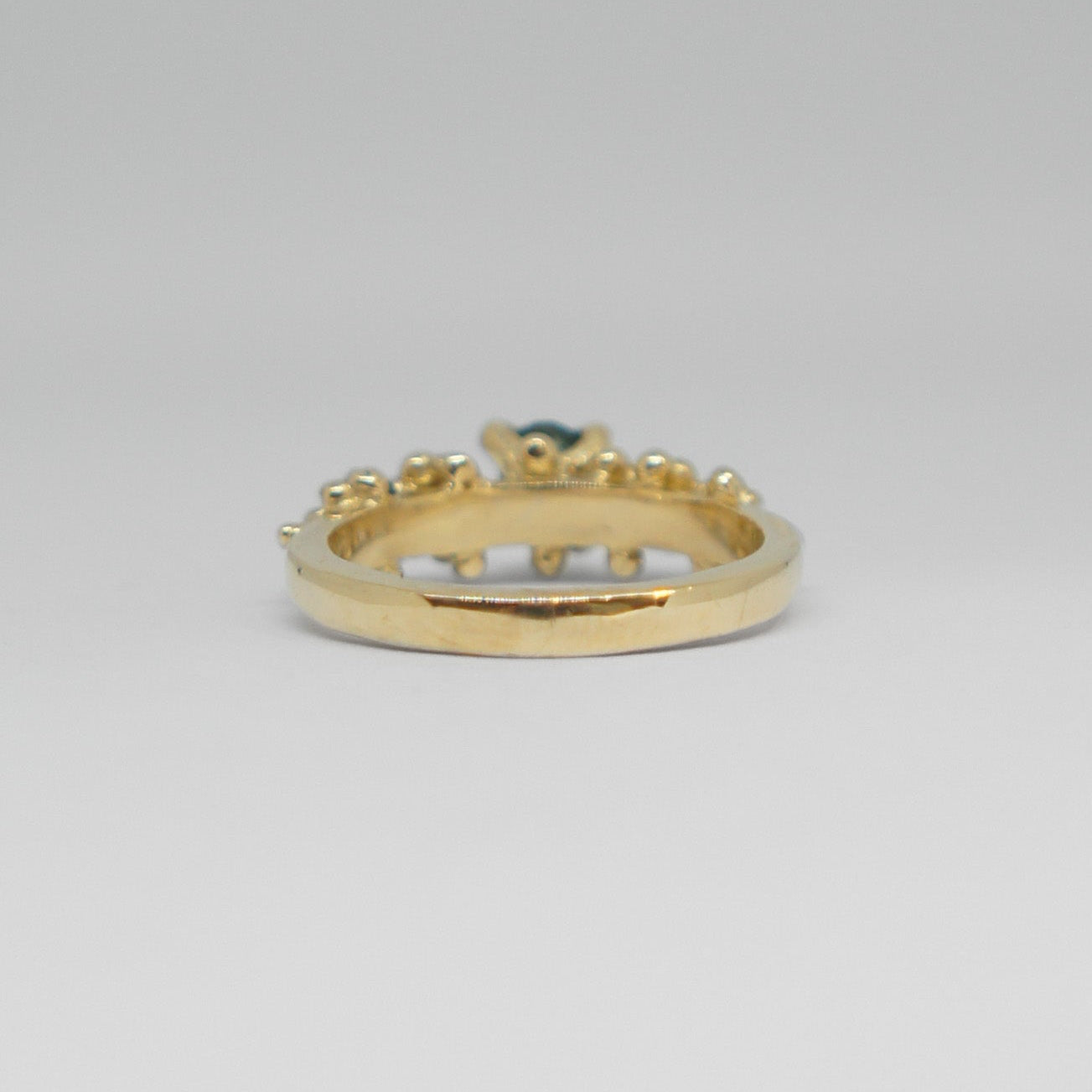 Gold ring with a green gemstone