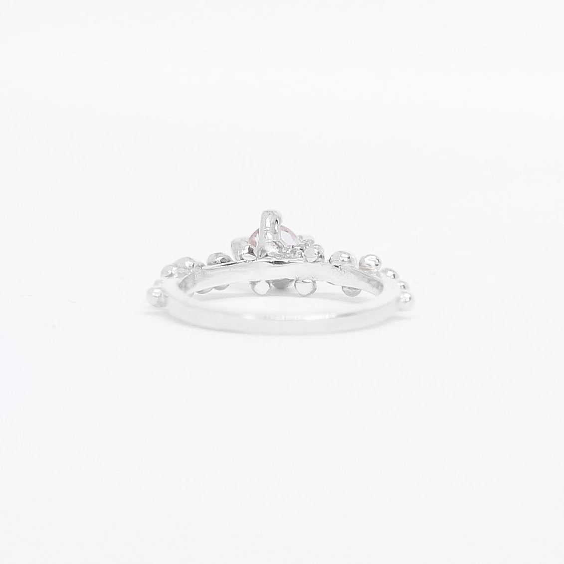 Silver ring with small diamonds on a white background
