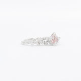 Silver ring with a pink gemstone on a white background