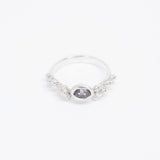 Silver ring with a dark gemstone on a white background