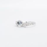 Silver ring with a blue gemstone on a white background