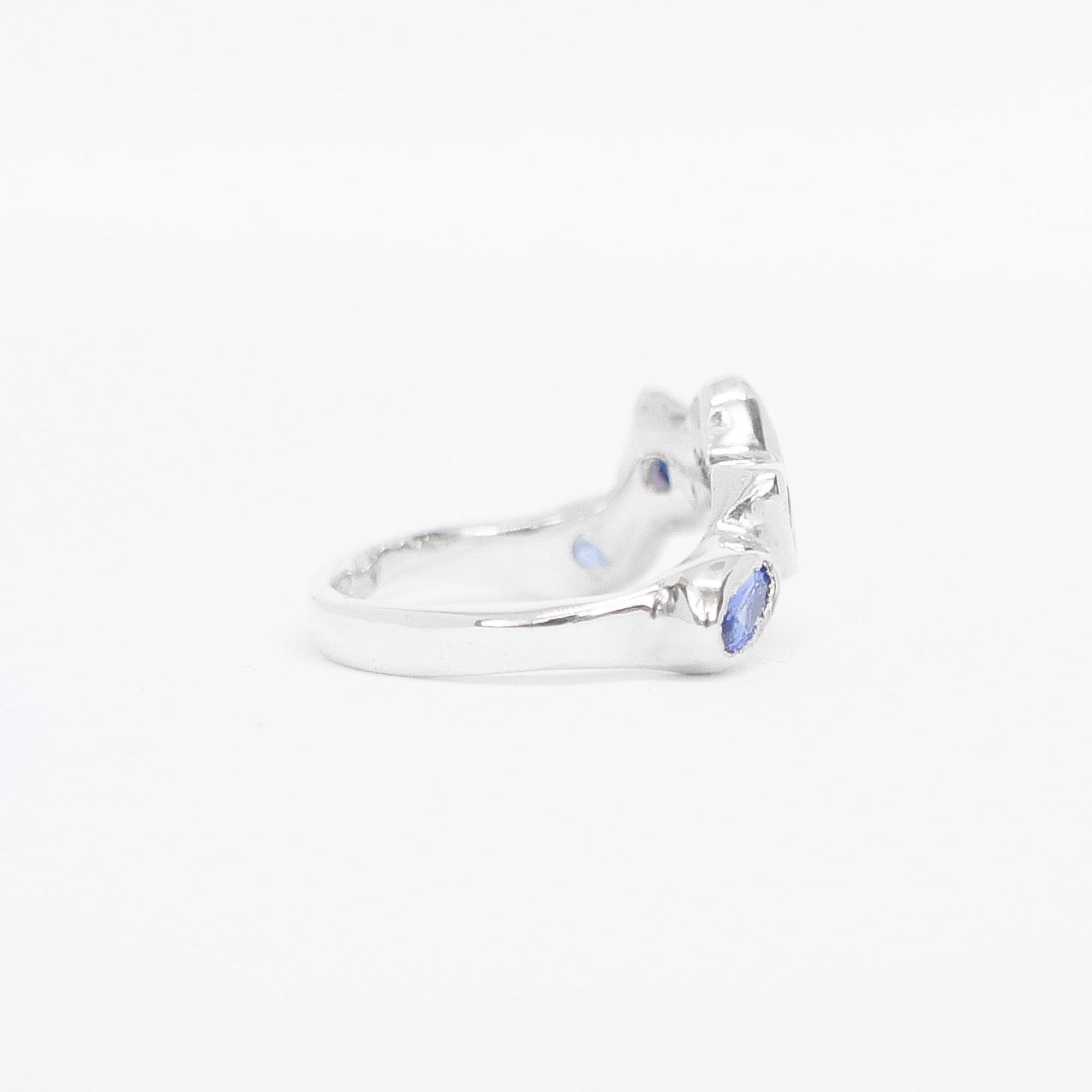 Silver ring with blue gemstone on a white background