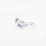 Silver ring with blue gemstones on a white background