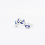 Silver ring with blue gemstones on a white background