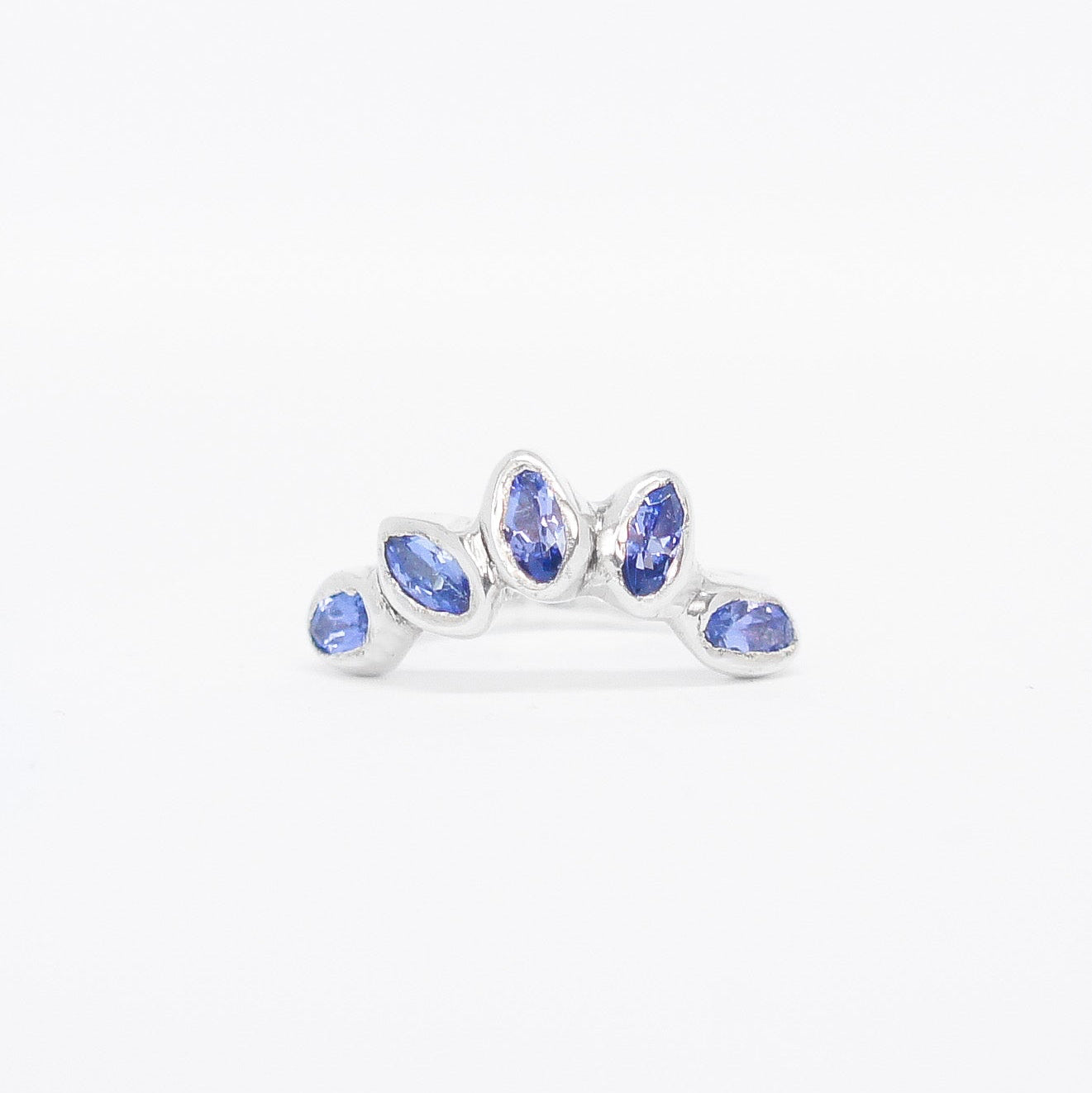 Silver ring with blue gemstones on a white background