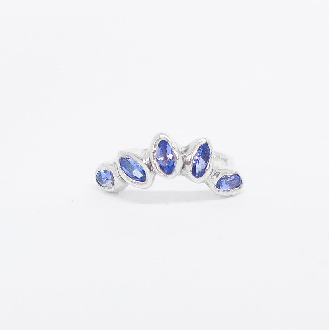 Silver ring with blue gemstones on a white background