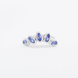Silver ring with blue gemstones on a white background