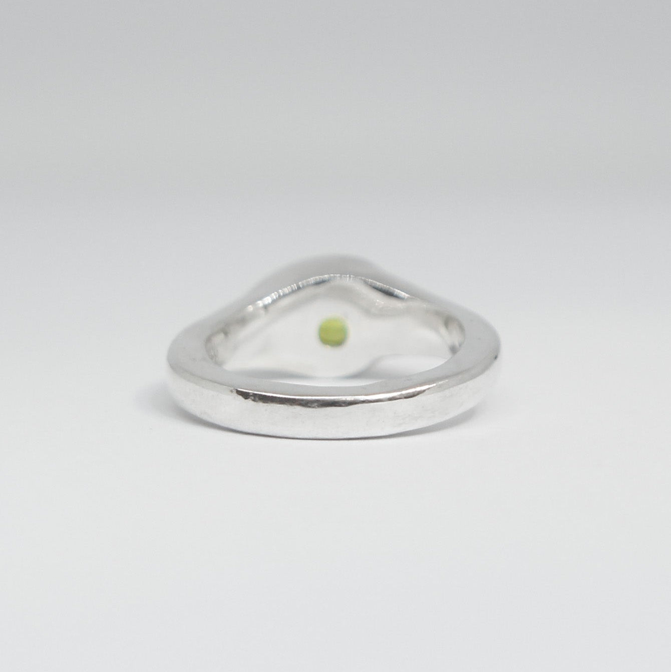 Silver ring with a green gemstone