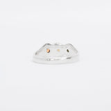 Silver ring with three colored stones on a white background