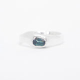 Silver ring with a blue stone on a white background