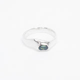 Silver ring with a green gemstone on a white background
