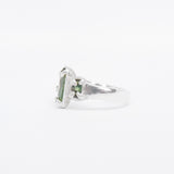 Silver ring with a green tourmaline gemstone on a white background