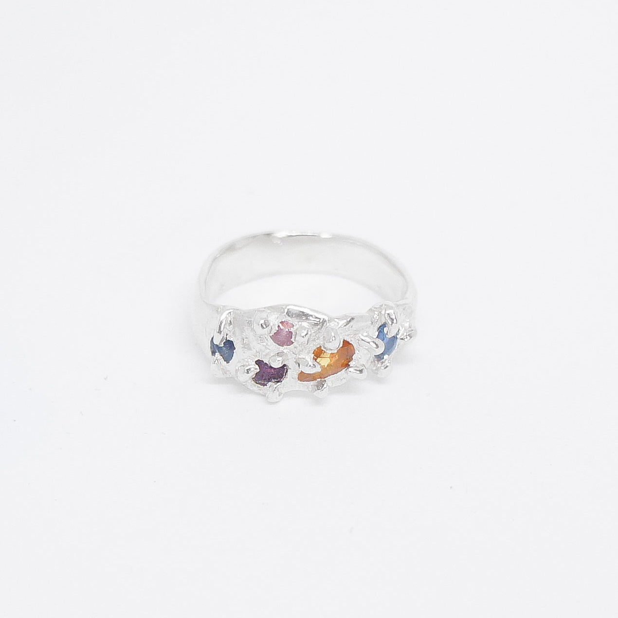 Clear ring with colorful stones on a white background