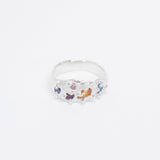 Clear ring with colorful stones on a white background