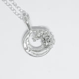 Silver necklace with a wave-shaped pendant on a light gray background