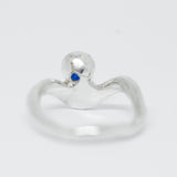 Silver ring with a blue gemstone on a white background