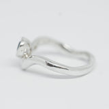 Silver ring on a light gray background