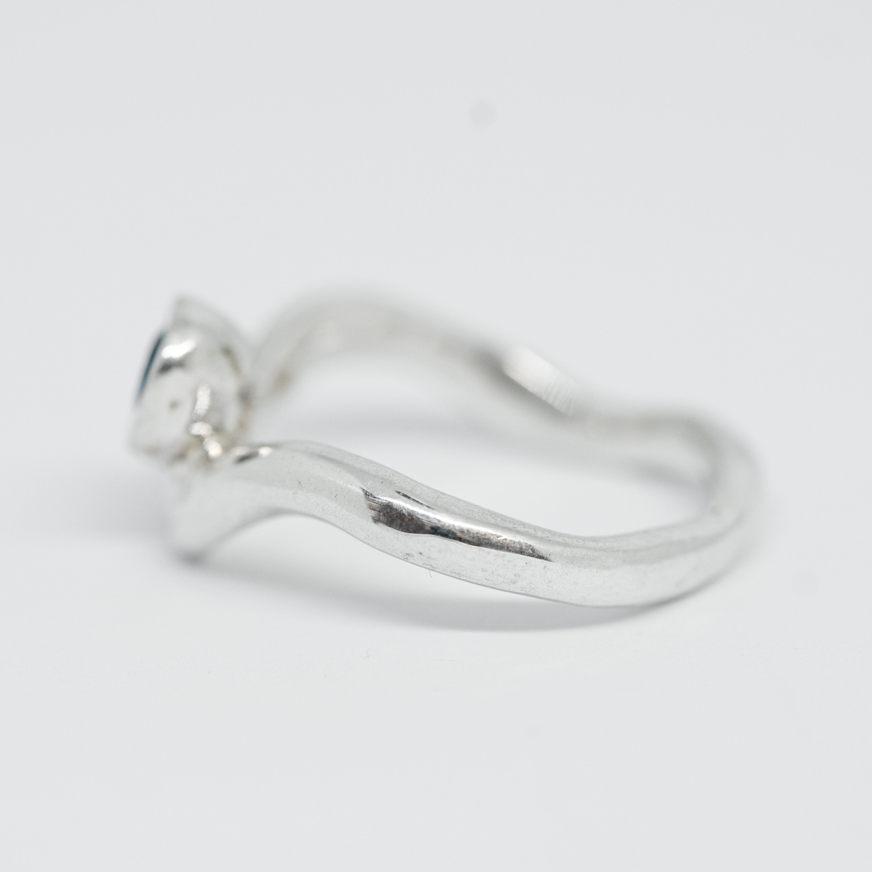Silver ring on a light gray background