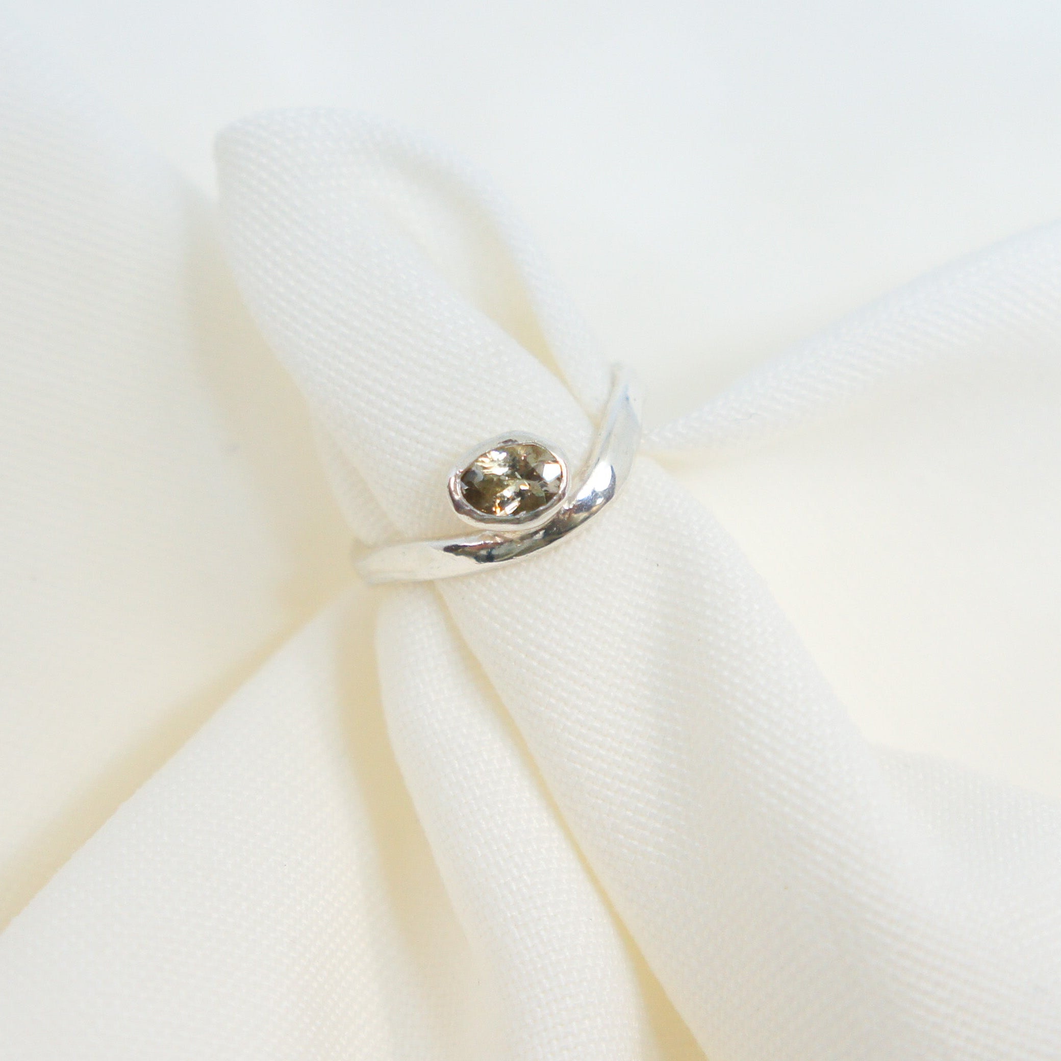 Close-up of a white fabric with a button on a light background