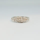 Silver ring with intricate design on a light gray background