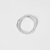 Silver ring on a light gray background