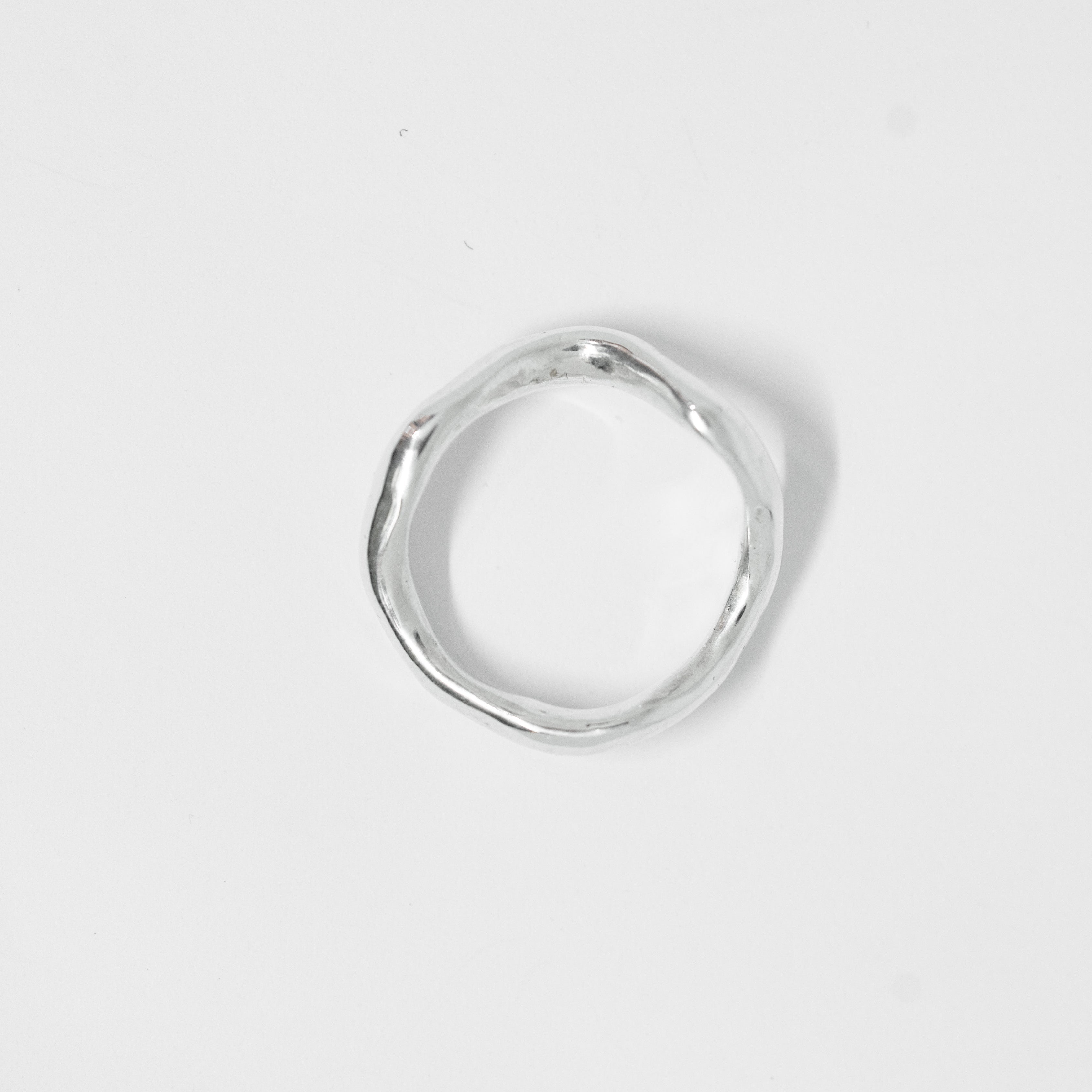 Silver ring on a light gray background