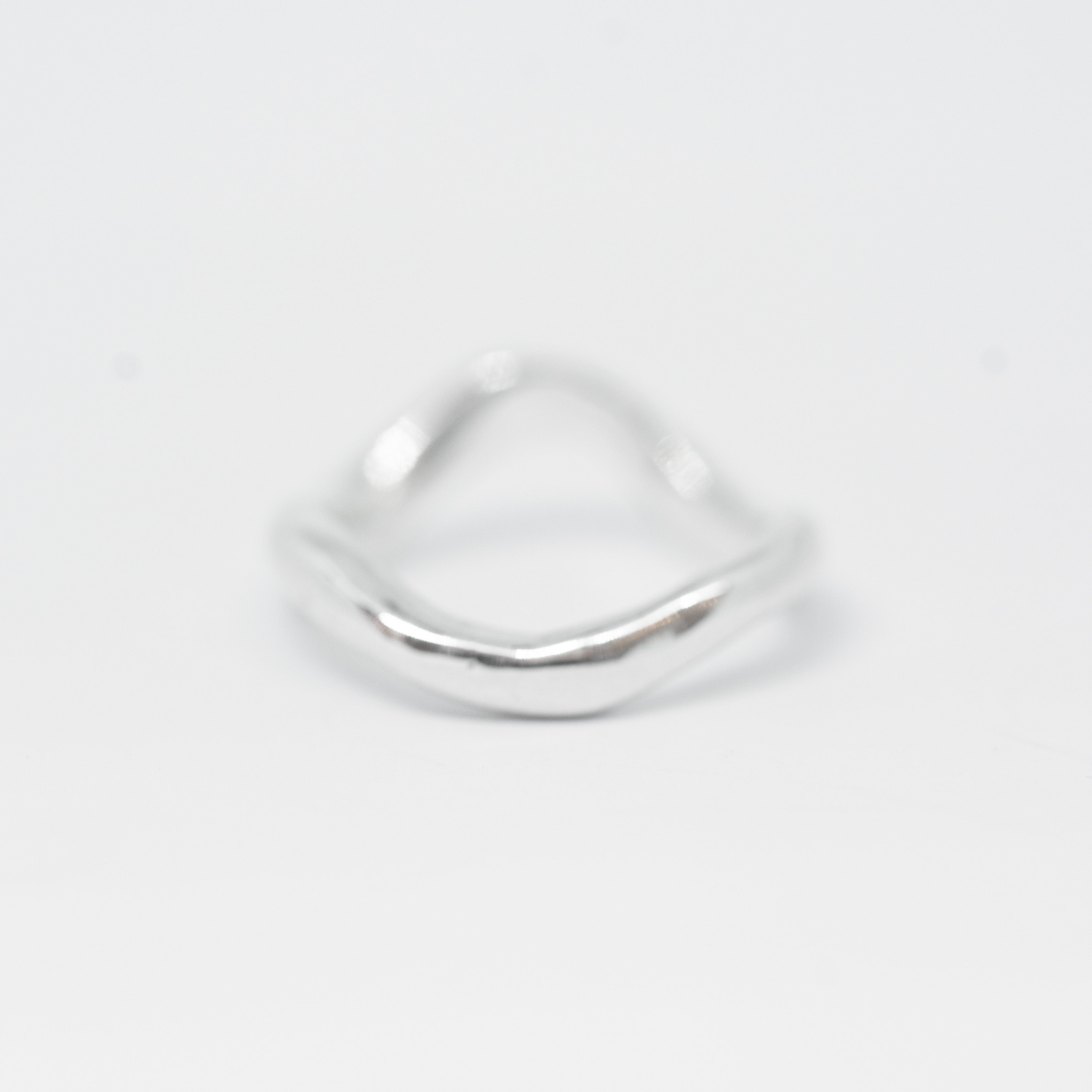 Silver ring on a light gray background